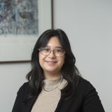 Woman sitting at a table smiling