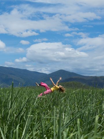 Dancer jumping in cane field