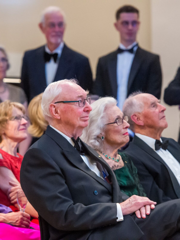 People in formal attire sitting in rows