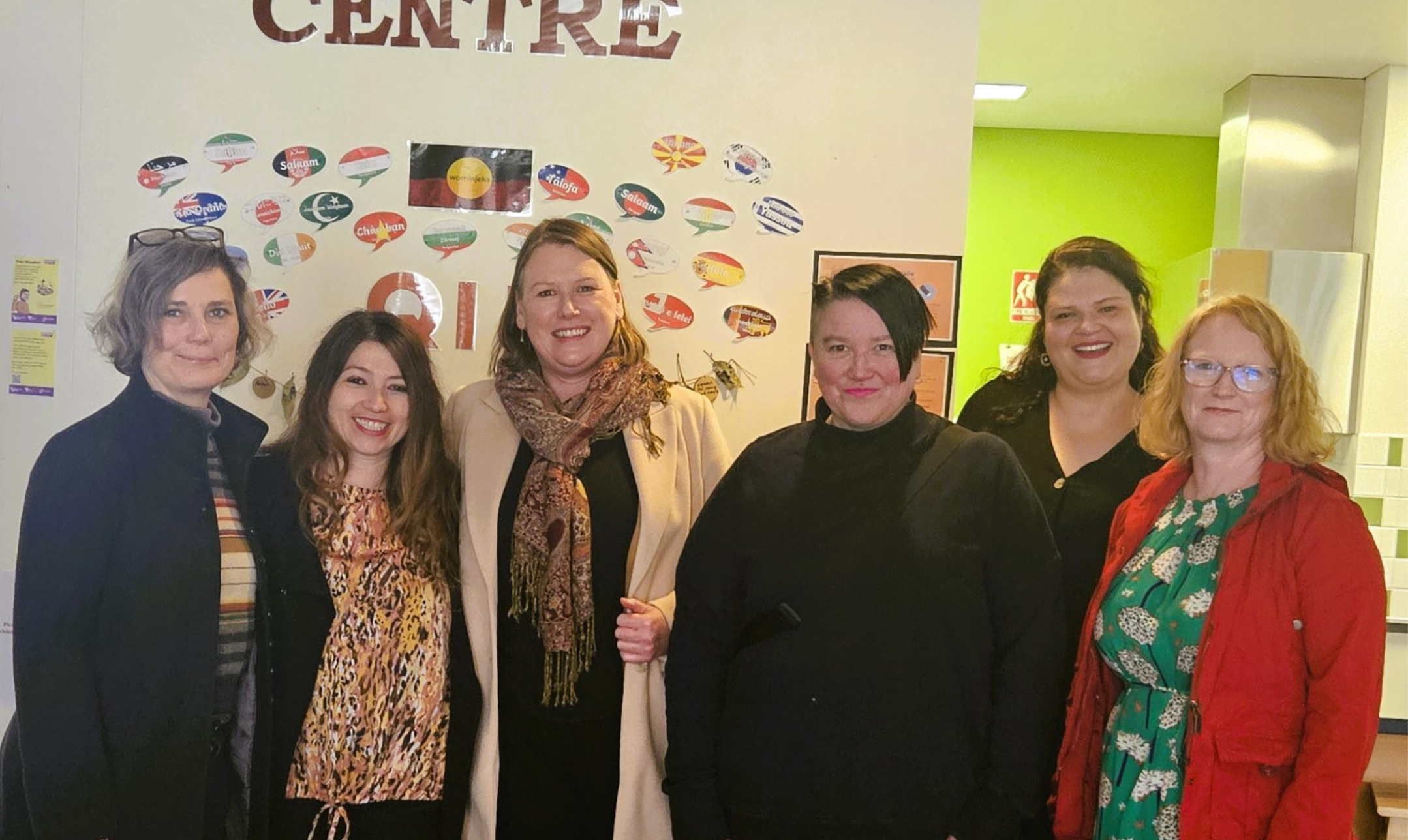 Six women standing under the Koring Koring Child and Family Centre sign