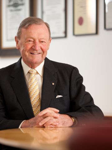 Man in suit sitting at board table