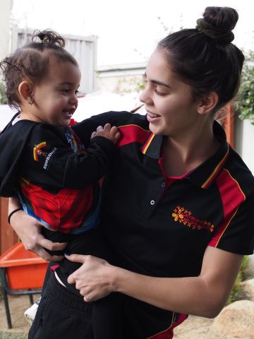 Woman holding toddler on her hip