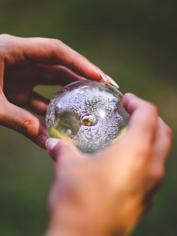 Hands holding glass ball
