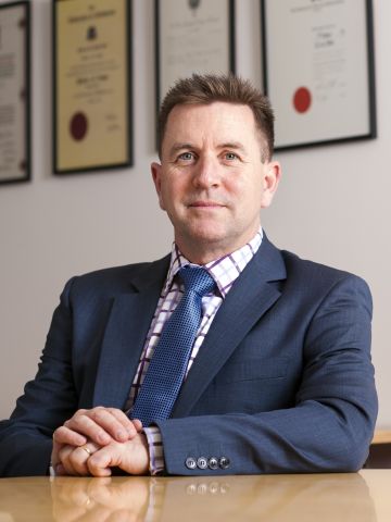 Man in suit sitting at table