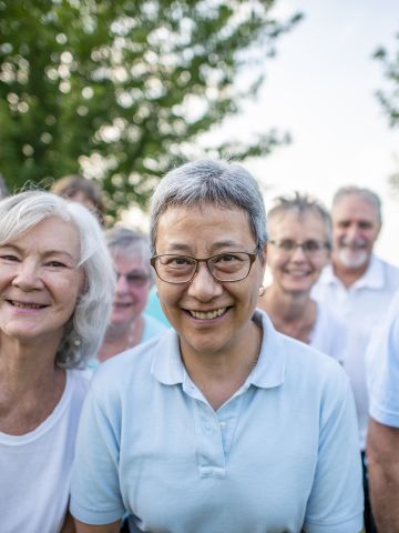 Group of older men and women in t-shirts smiling